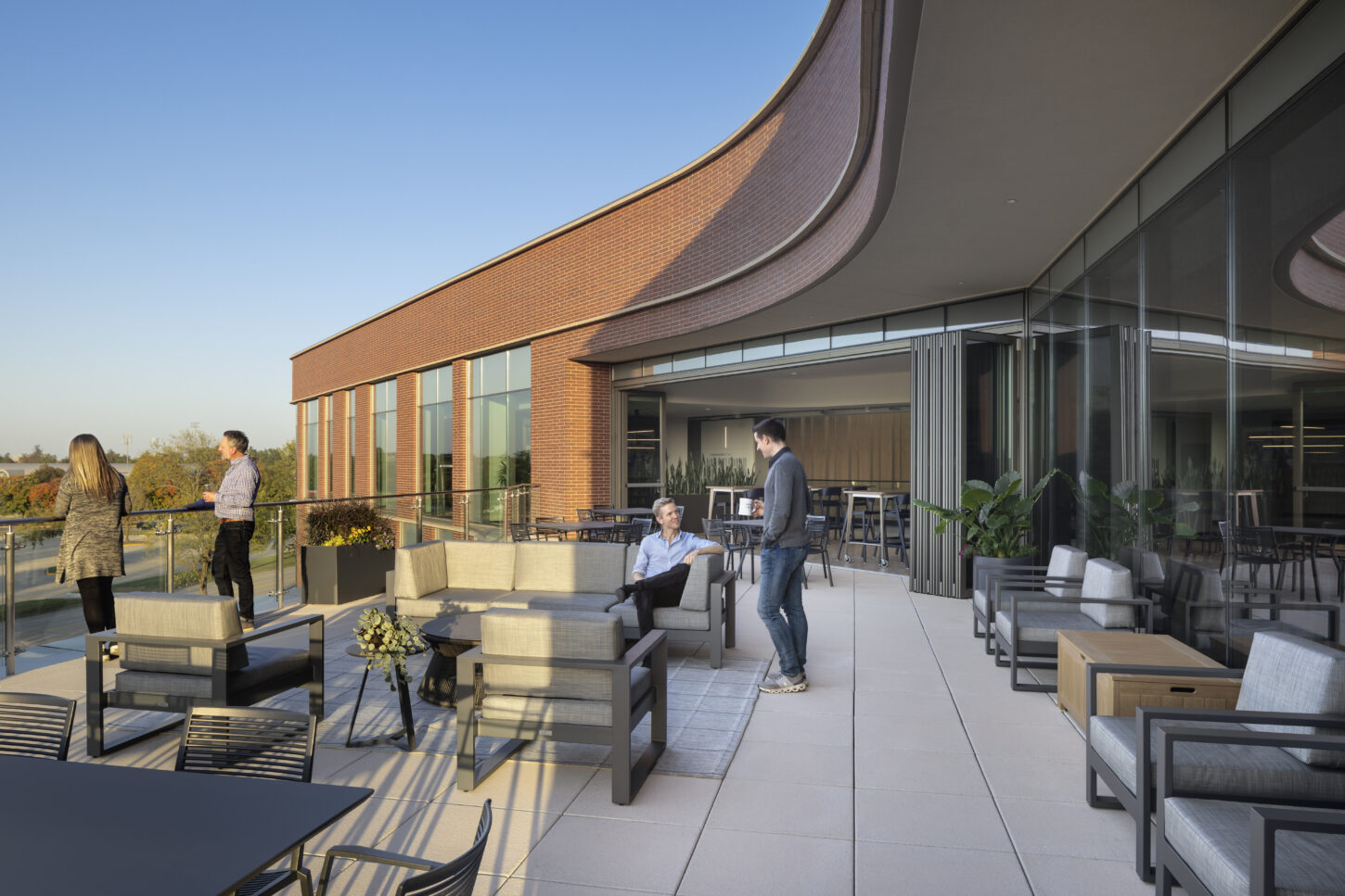 https://www.pmainc.com/wp-content/uploads/2023/08/Univ-of-Illinois-Foundation-HQ_Photo-Ext-Terrace-w-People_Photograph-by-Andrew-Rugge-Copyright-Perkins-Eastman-1450x967.jpg