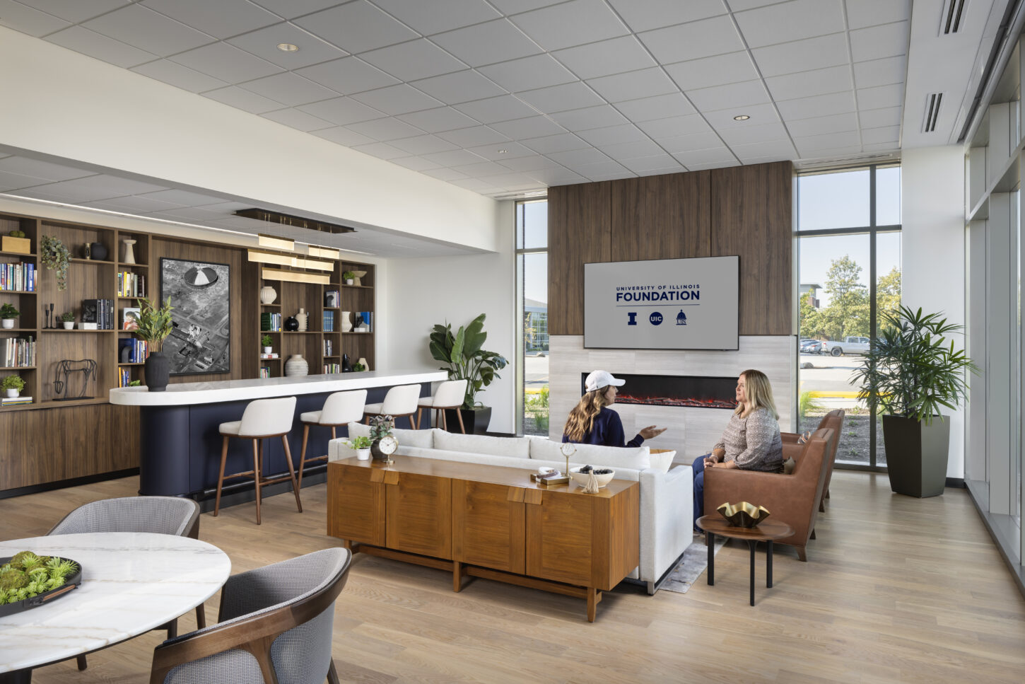 https://www.pmainc.com/wp-content/uploads/2023/08/Univ-of-Illinois-Foundation-HQ_Photo-Int-Library-w-People_Photograph-by-Andrew-Rugge-Copyright-Perkins-Eastman-1450x967.jpg